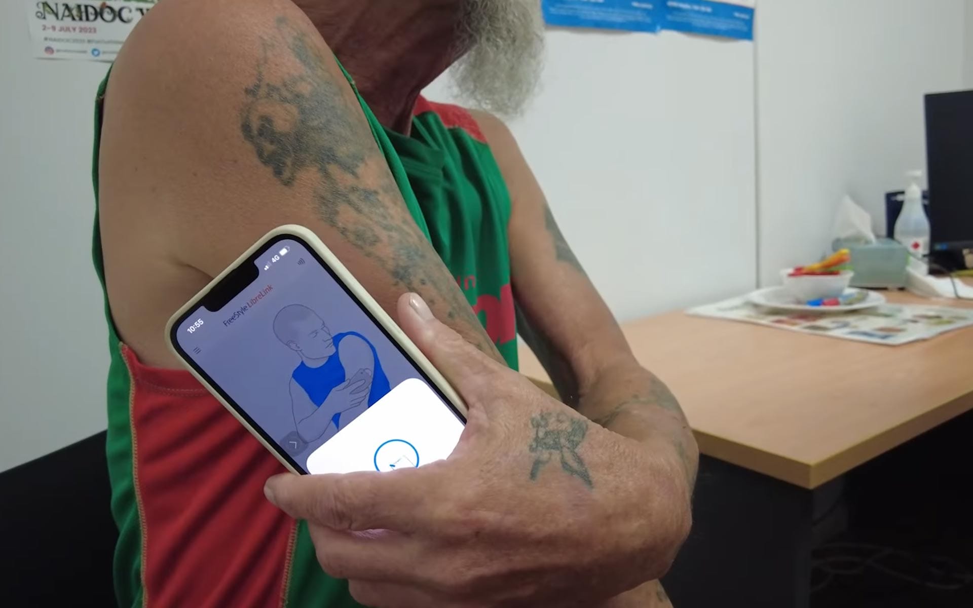 Person scanning their arm with a smartphone for a diabetes test